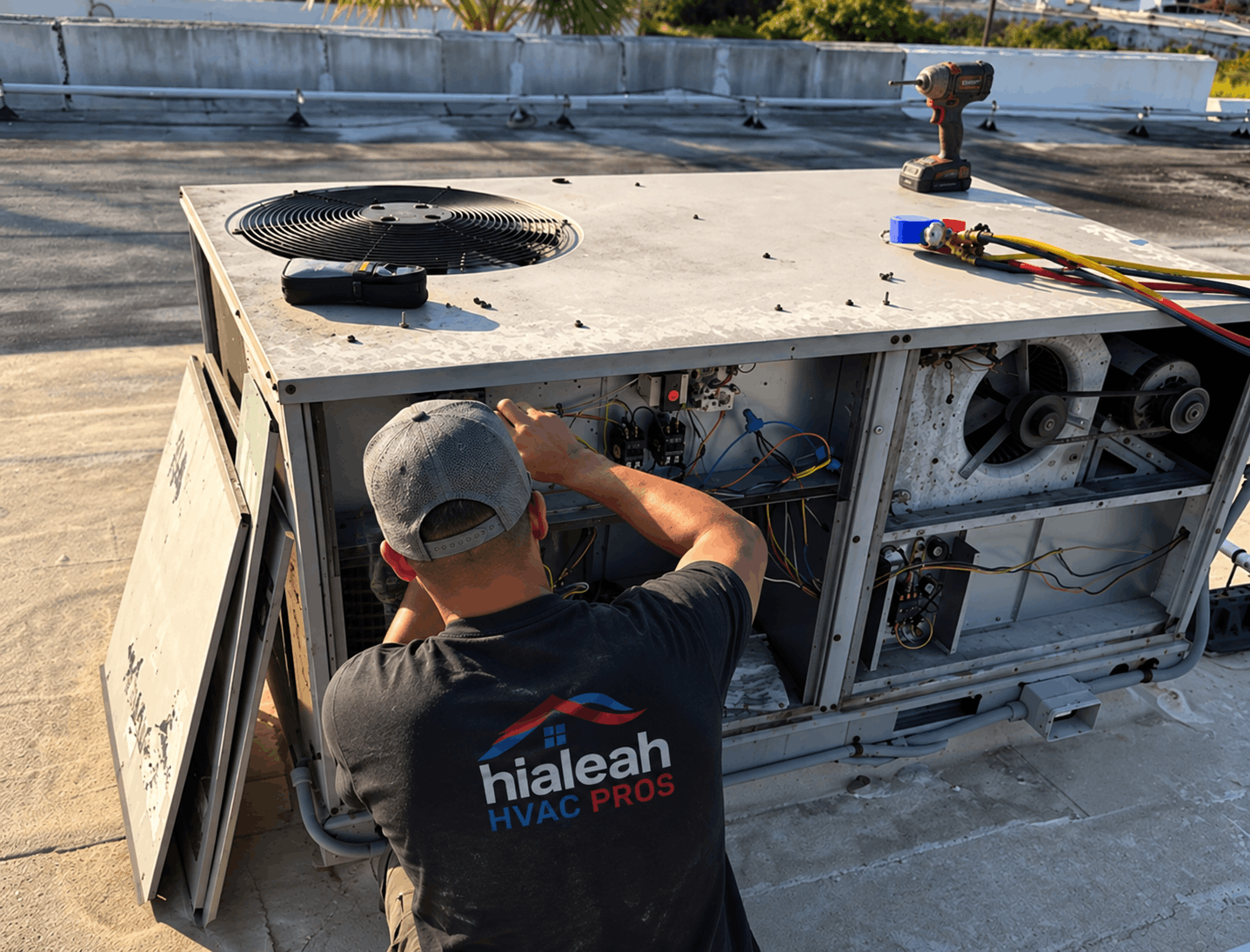 Technician repairing AC roof unit in Hialeah home